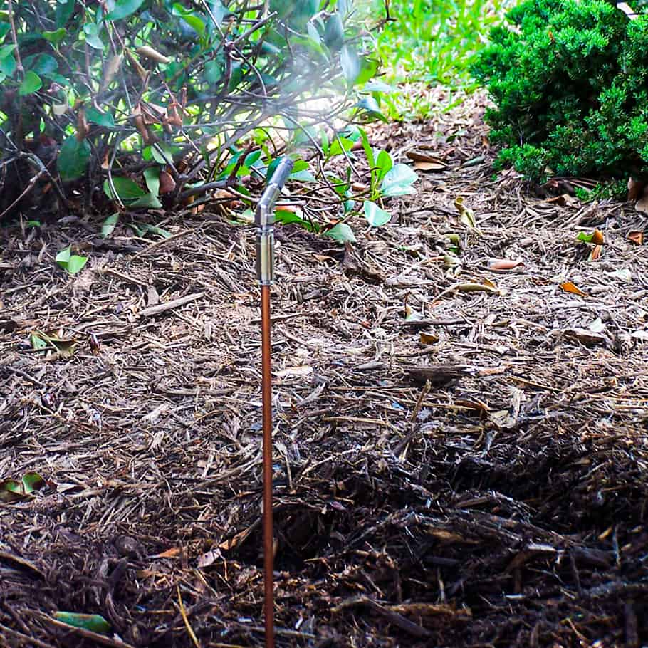 riser Sprinkler watering mulch in a garden